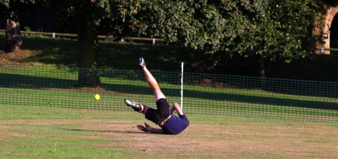 Error 404 image of softballer falling over in outfield